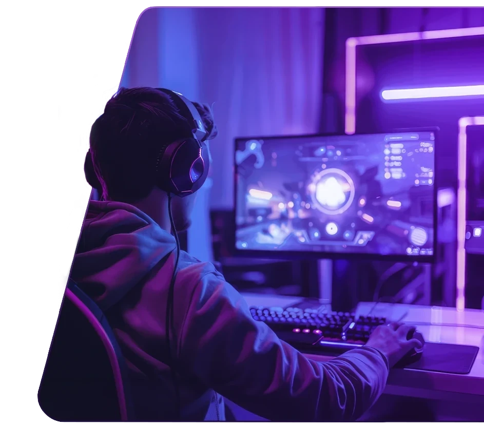 Jovem sentado de costas, jogando no computador.