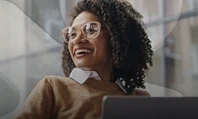 Pessoa utilizando notebook em escritório com selo Mês do Cliente em destaque.